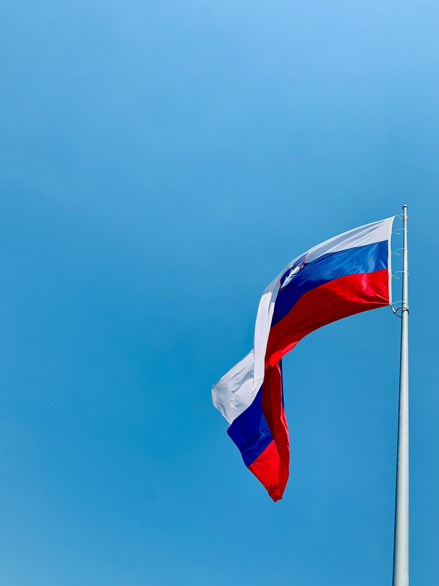 A red, white and blue flag flying in the wind